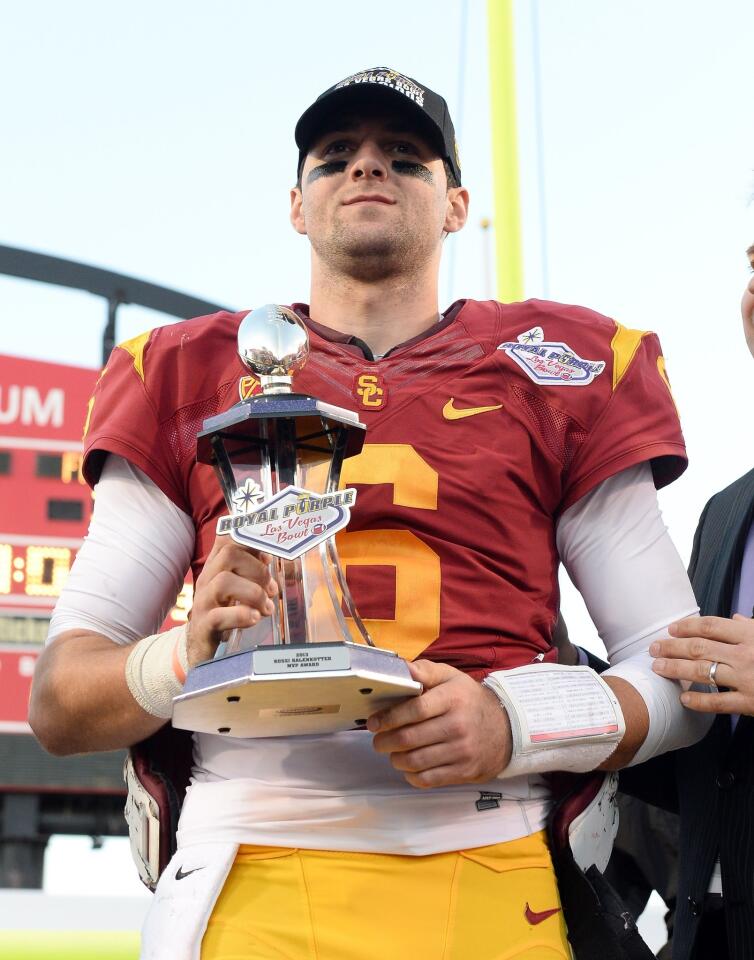 Trojans quarterback Cody Kessler is presented the trophy for most valuable player in the Las Vegas Bowl.