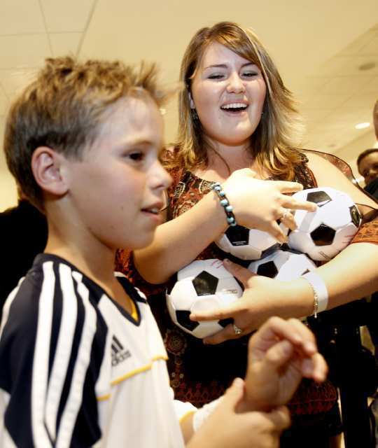 Justine Leedom, right, of Foothill Ranch, leaves with son Lance, 10, with four balls and a jersey signed by Landon Donovan of the L.A. Galaxy.