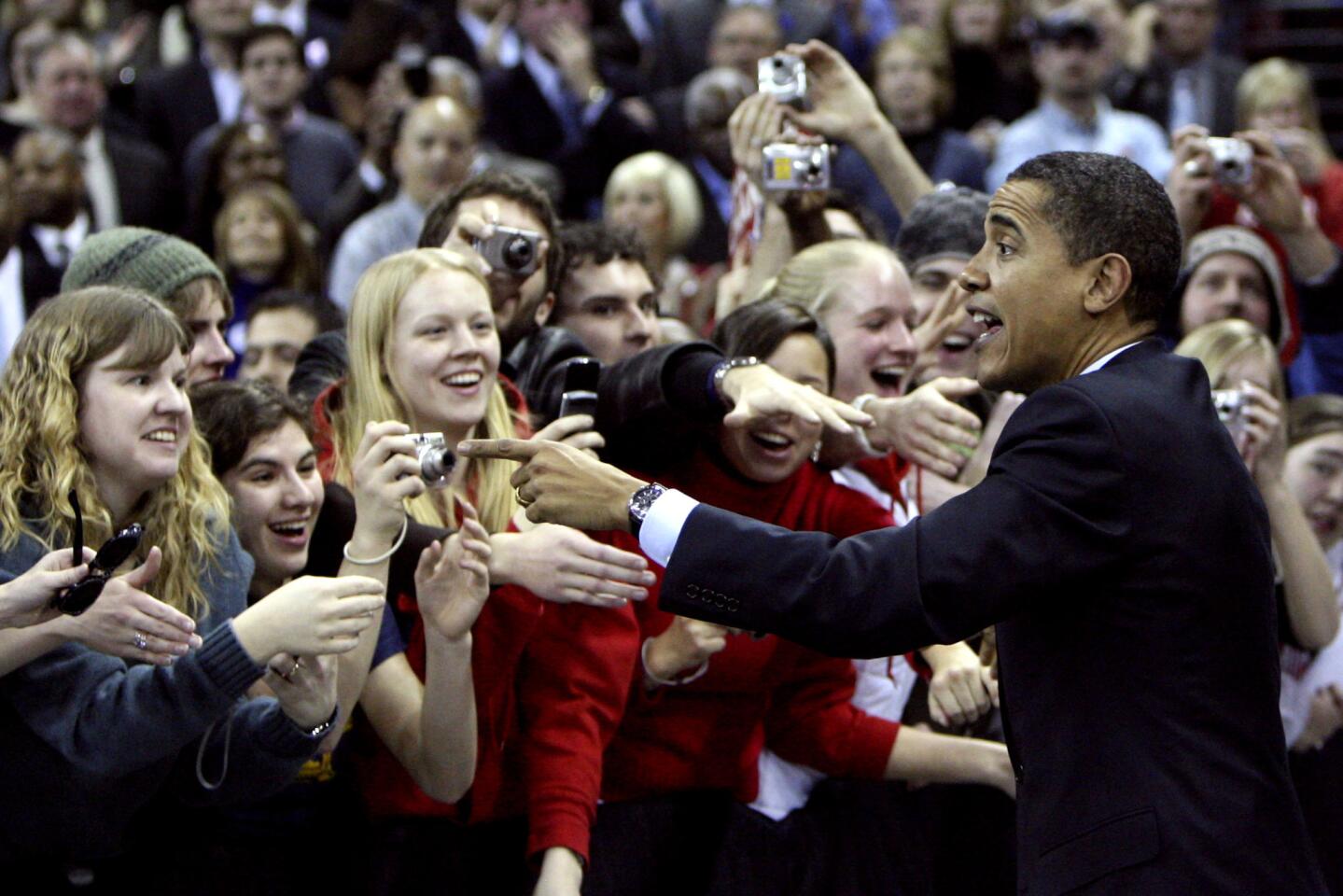 In this Feb. 12, 2008, photo, presidential candidate Sen. Barack Obama greets supporters before a rally in Madison, Wis. President Obama is returning to the University of Wisconsin to ask young voters who helped propel him to the White House to support Democrats in key governor and U.S. Senate races.