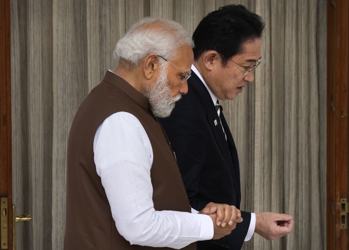 Japan's Prime Minister Fumio Kishida, right, and Indian Prime Minister Narendra Modi, talk before their delegation level meeting in New Delhi, India, Monday, March 20, 2023. (AP Photo/Manish Swarup)
