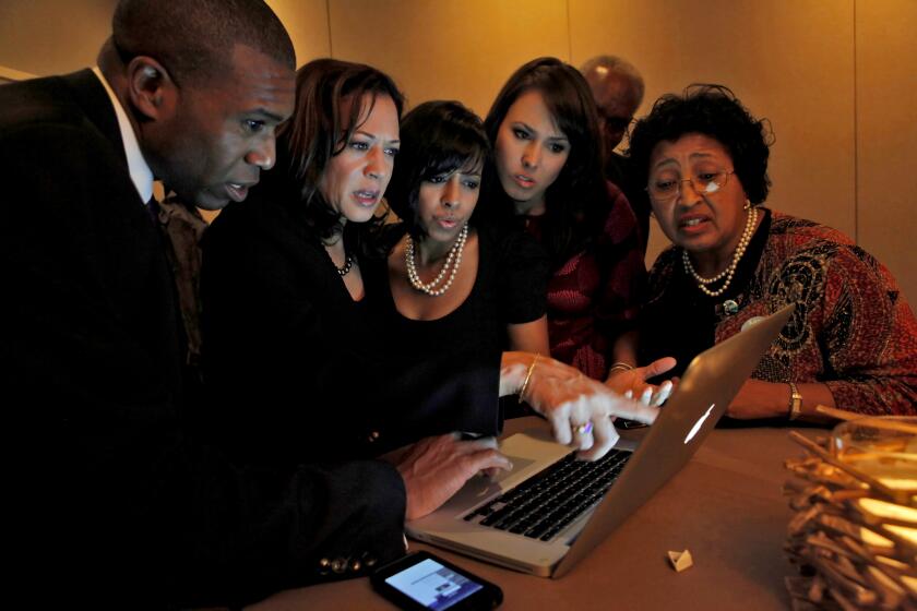 Tony West, left and Kamala Harris look up the poll results with family Maya Harris, Meena Harris and parents Frank and Peggy Harris at the Hotel Vitale, Tuesday Nov. 2, 2010, in San Francisco, Calif. (Photo by Lacy Atkins/San Francisco Chronicle via Getty Images)