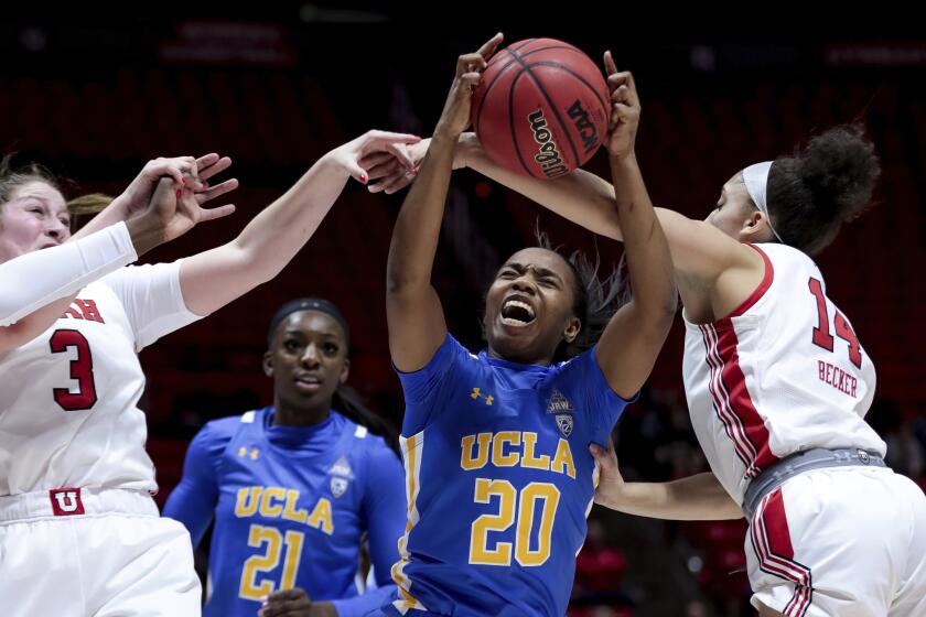 UCLA guard Charisma Osborne (20) pulls in a rebound between Utah' Andrea Torres (3) and Niyah Becker (14) during an NCAA college basketball game in Salt Lake City on Friday, Jan. 10, 2020. (Spenser Heaps/The Deseret News via AP)