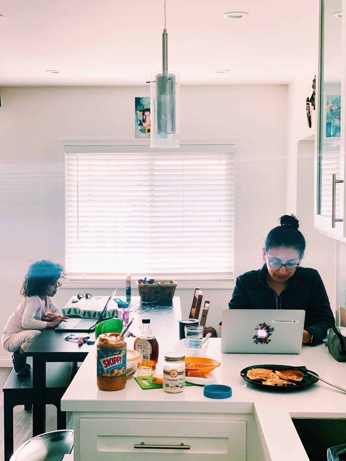 Alma Zaragoza-Petty of Los Angeles has the morning shift home-schooling her children.