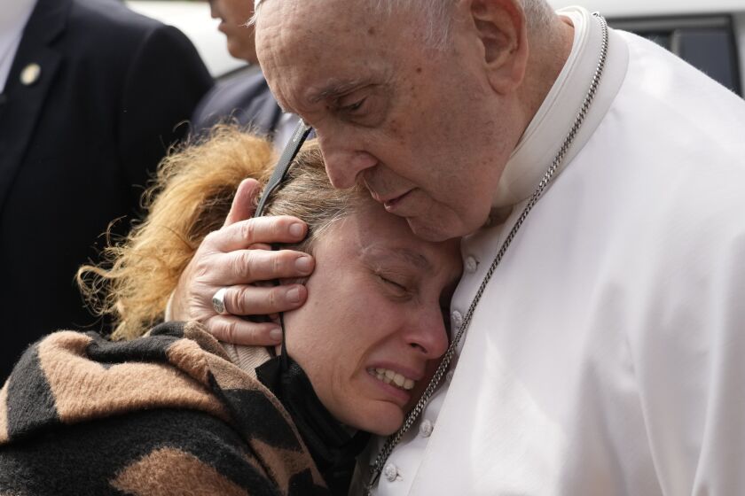 Pope Francis consoles Serena Subania who lost her daughter Angelica, 5 years old, the day before as he leaves the Agostino Gemelli University Hospital in Rome, Saturday, April 1, 2023 after receiving treatment for a bronchitis, The Vatican said. Francis was hospitalized on Wednesday after his public general audience in St. Peter's Square at The Vatican. (AP Photo/Gregorio Borgia)