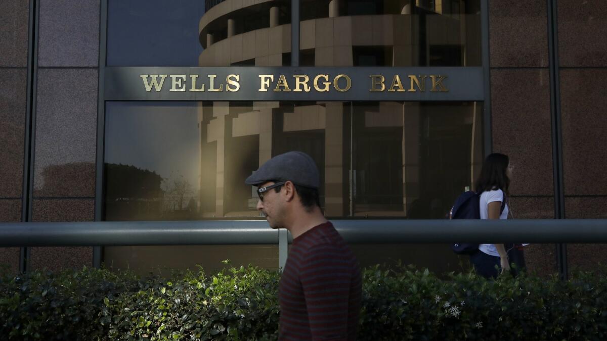 Pedestrians walk past a Wells Fargo branch in downtown Los Angeles.