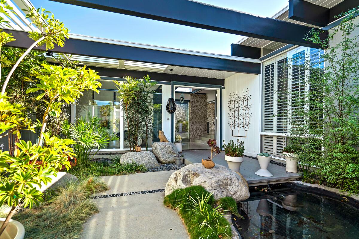 A shallow pond sits at the entrance to our Midcentury Modern Home of the Week in Bel-Air.