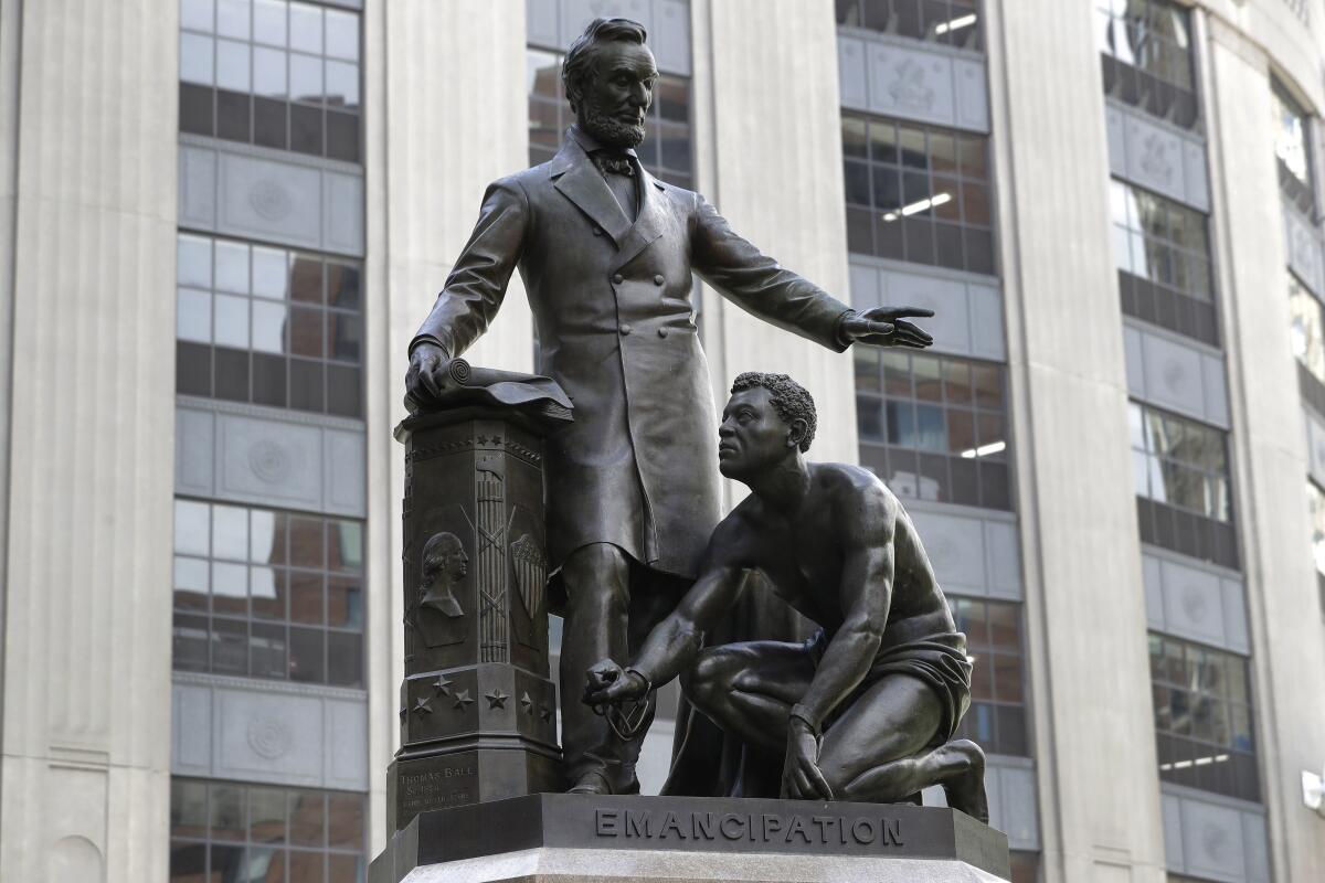 Statue of slave kneeling at Abraham Lincoln's feet