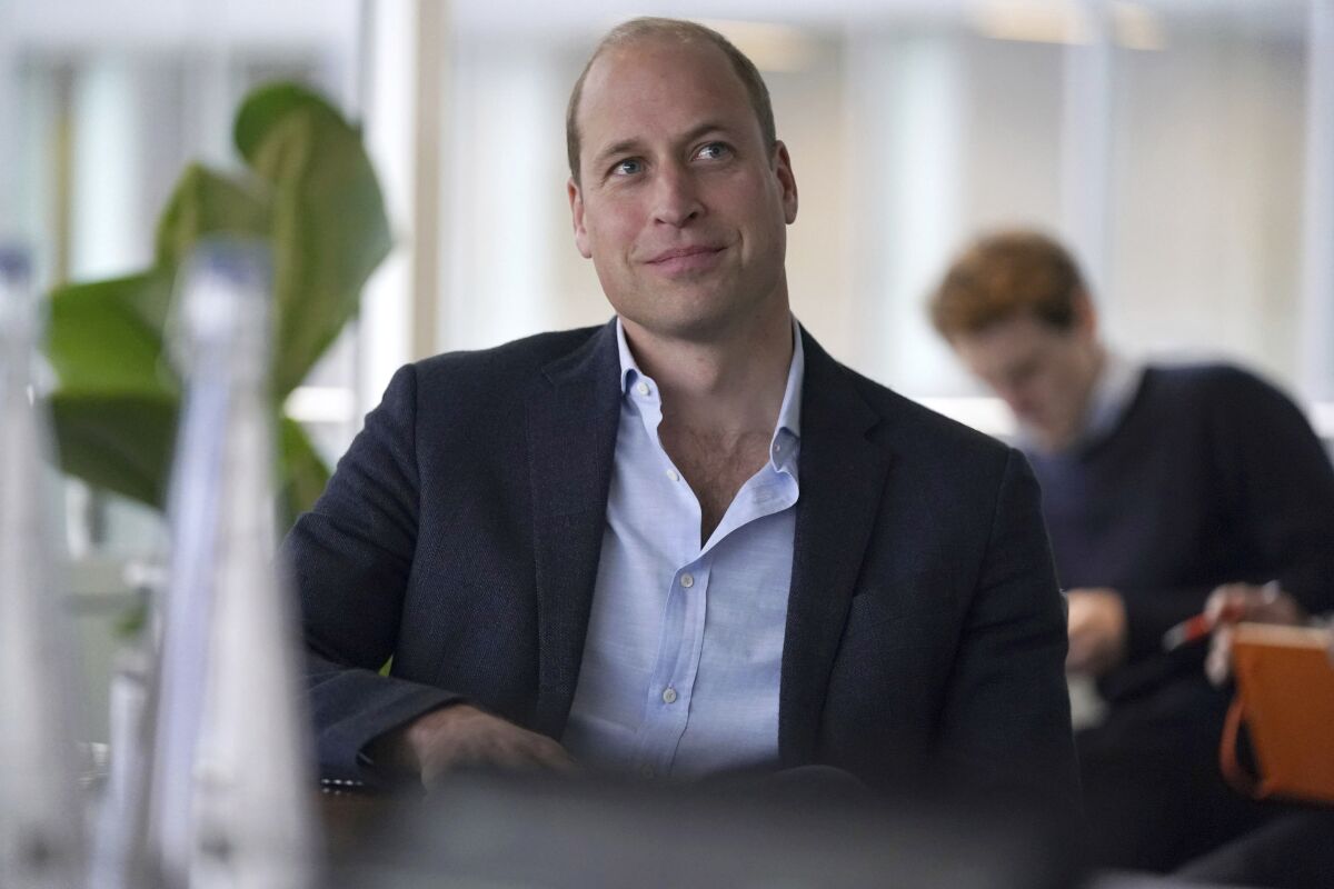 FILE - Britain's Prince William smiles during a visit to Microsoft HQ to learn how new AI scanning technology can increase detection of illegal wildlife products being trafficked through international airports, in Reading, England, Nov. 18, 2021. Prince William was grilled earlier this month about his Christmas favorites by children receiving cancer treatment at the Royal Marsden, a London hospital. William has visited the specialist cancer hospital a number of times since he became president of the Royal Marsden in 2007. (Steve Parsons/Pool Photo via AP, File)