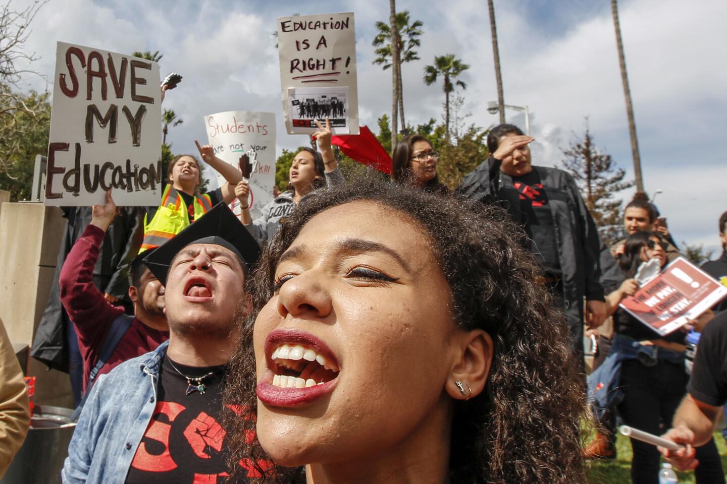 Maya Canales protests outside Chancellor's office after Cal State Board of Trustees approved a tuition fee increase.