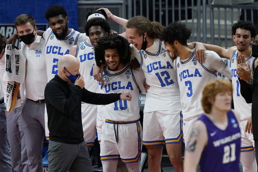 UCLA head coach Mick Cronin jokes with players in the final moments of their 67-47 win over Abilene Christian.