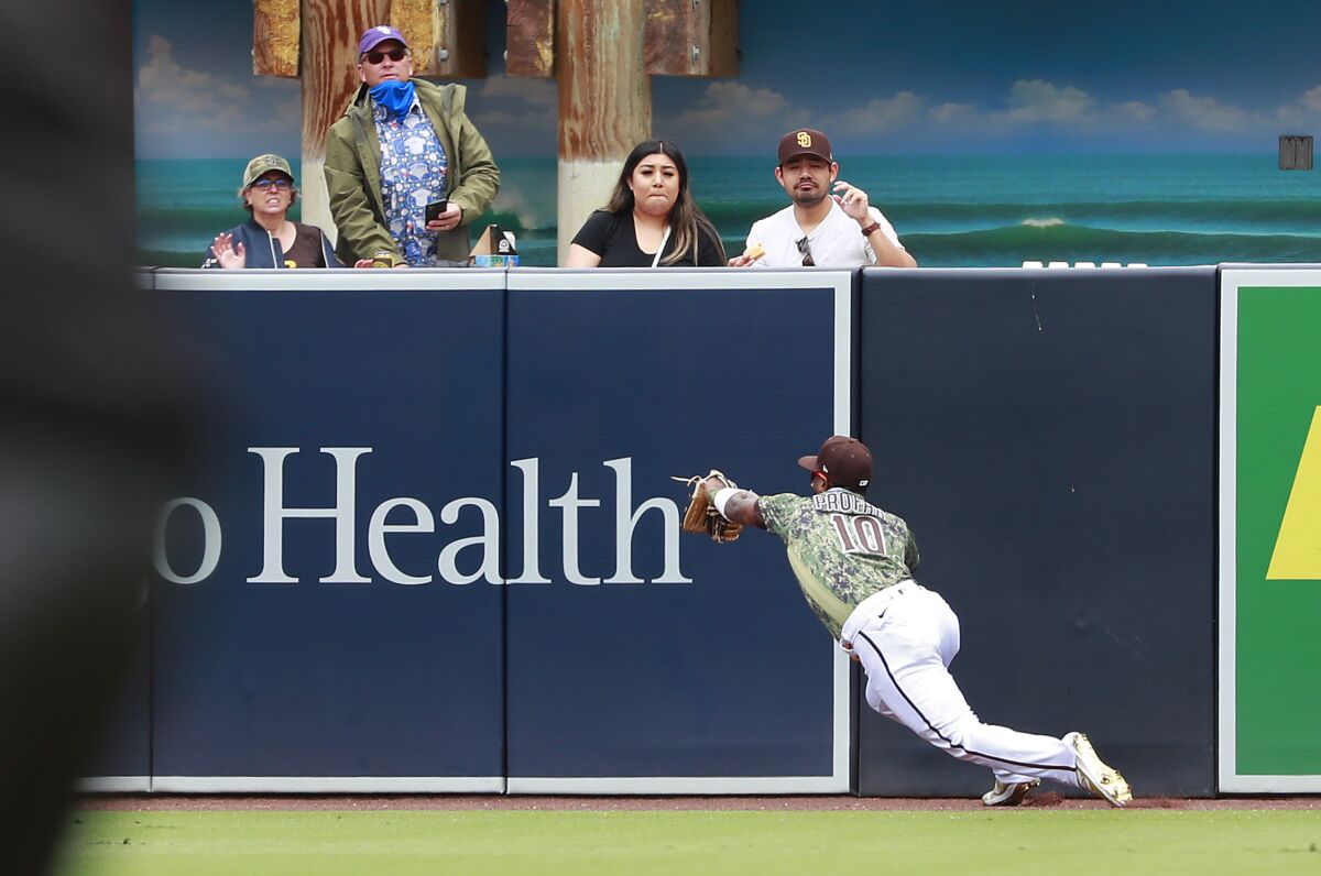 SAN DIEGO, CA - MAY 02: San Diego Padres' Jurickson Profar dives to make a catch on a fly ball by San Francisco 