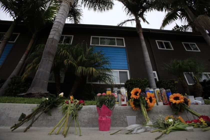 Flowers are placed outside the apartment where Elliot Rodger lived and allegedly fatally stabbed his roommates.