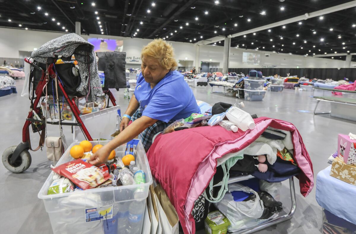 Letisha Vazquez goes through her belongings at the Convention Center homeless shelter in 2020.