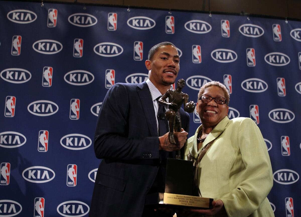Derrick Rose poses with his mother, Brenda Rose, after accepting the MVP trophy in 2011. (Chris Sweda / Chicago Tribune)