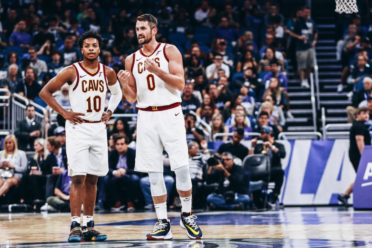 Cavaliers forward Kevin Love, 0, talks with rookie guard Darius Garland,10, during a game Oct. 23 against the Magic at Amway Center. 