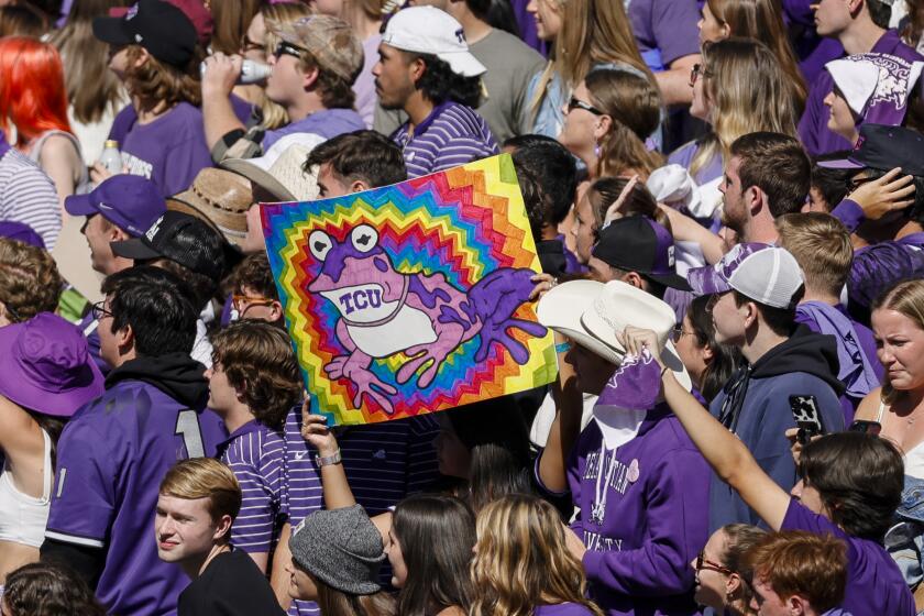 TCU Horned Frogs fans hold up a Hypnotoad sign 