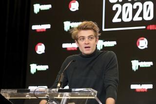 DAZN CEO Joseph Markowski sits in front of a table and speaks during a news conference 
