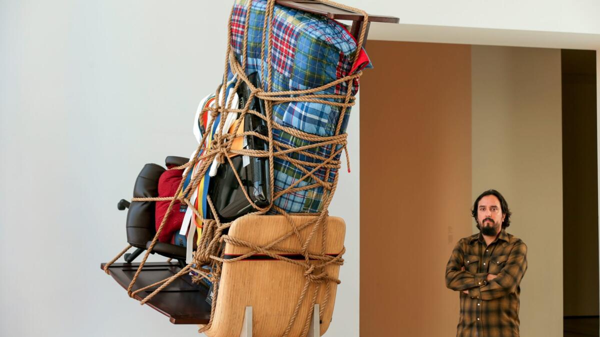 Artist Camilo Ontiveros with "Temporary Storage: The Belongings of Juan Manuel Montes."
