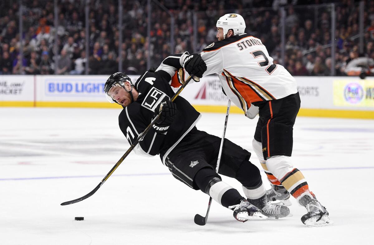 Ducks defenseman Clayton Stoner, right, pushes over Kings center Jeff Carter during the second period on Apr. 7.