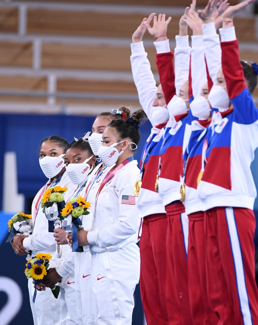 Simone Biles unsure she will compete remainder of Olympics - Los Angeles Times 3 Simone Biles, second from left, watches the ROC team celebrate their gold medal.
