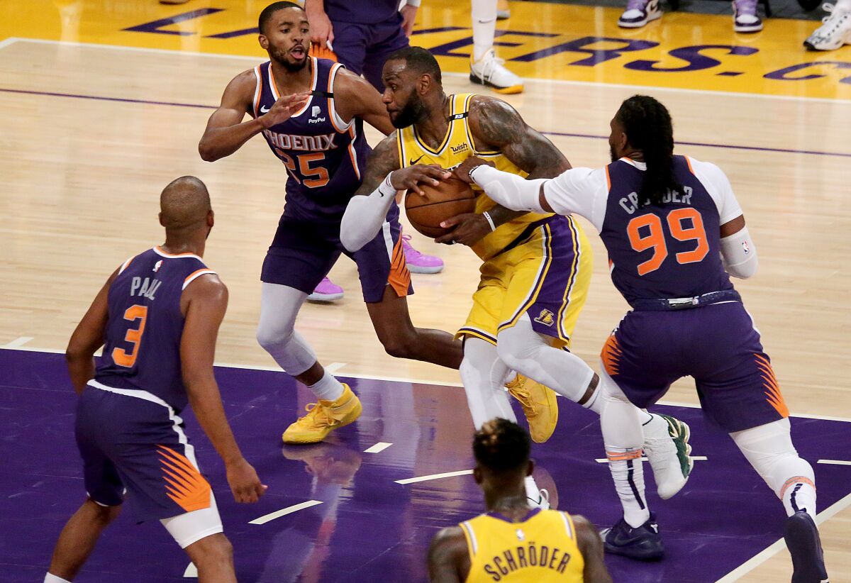 Lakers forward LeBron James drives to basket against the Suns.
