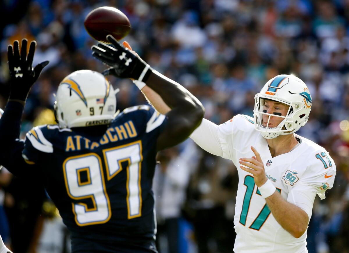 Chargers outside linebacker Jeremiah Attaochu gets in the face of Dolphins quarterback Ryan Tannehill during the first half of a game on Dec. 20.