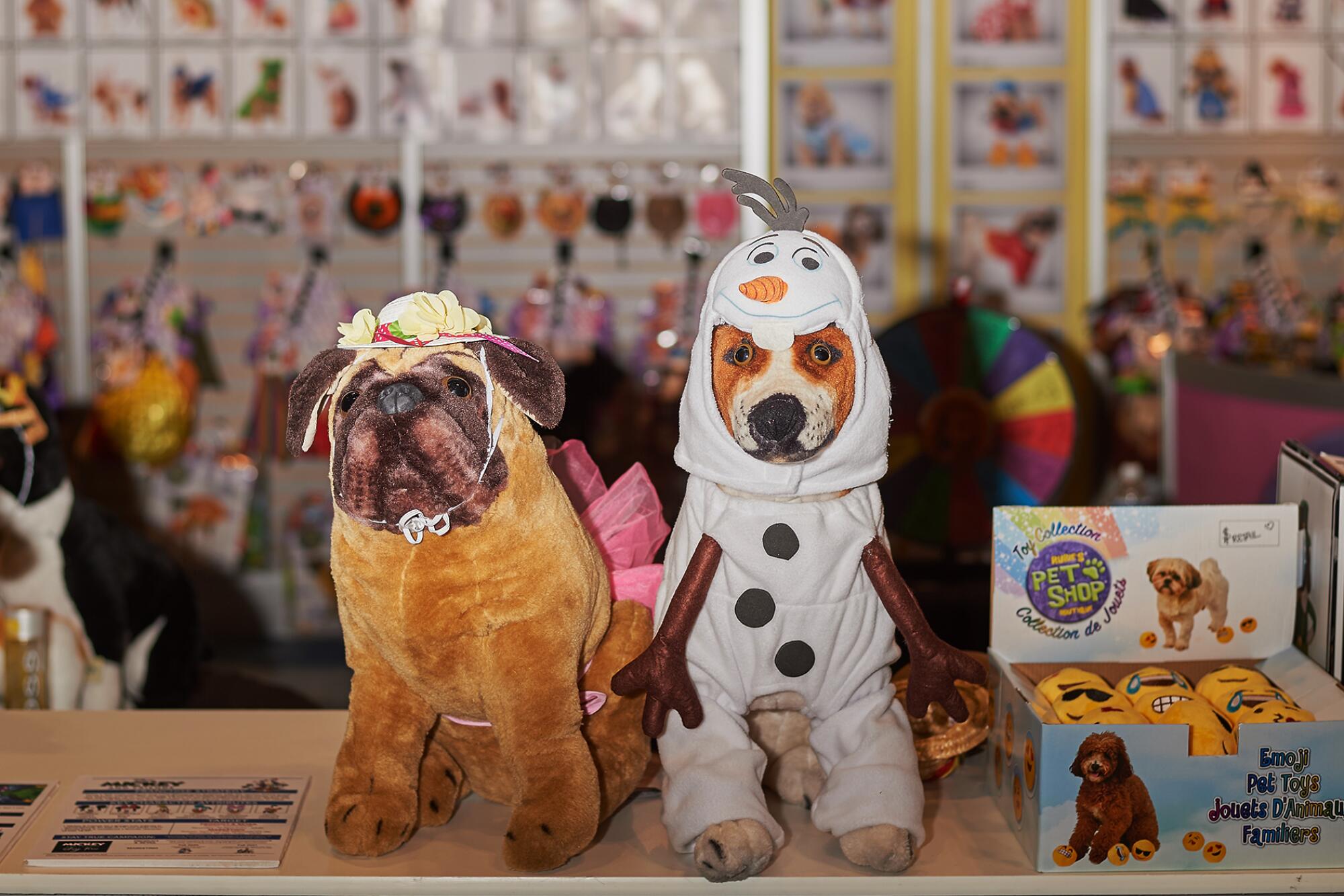 Pet costumes are displayed on stuffed dogs at the Global Pet Expo in Orlando, Fla.