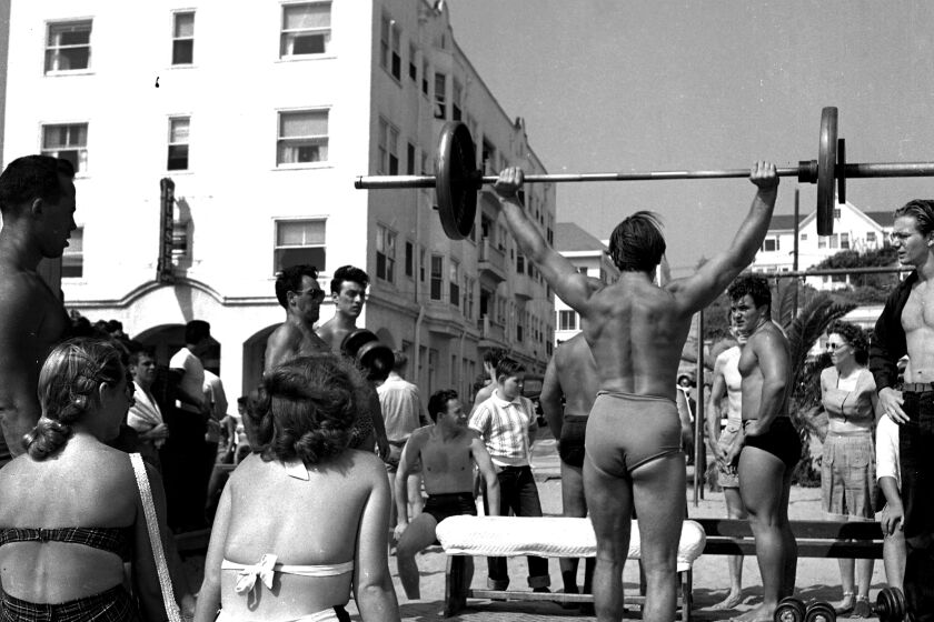 LOS ANGELES - JULY 24: A muscle builder lifts weights at Muscle Beach on July 24, 1949 in Santa Monica, California. (Photo by Earl Leaf/Michael Ochs Archives/Getty Images)