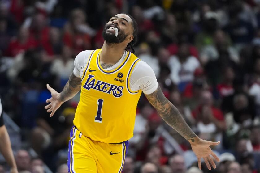 Los Angeles Lakers guard D'Angelo Russell (1) reacts after making a 3-point basket in the second half of an NBA basketball play-in tournament game against the New Orleans Pelicans Tuesday, April 16, 2024, in New Orleans. The Lakers won 110-106. (AP Photo/Gerald Herbert)