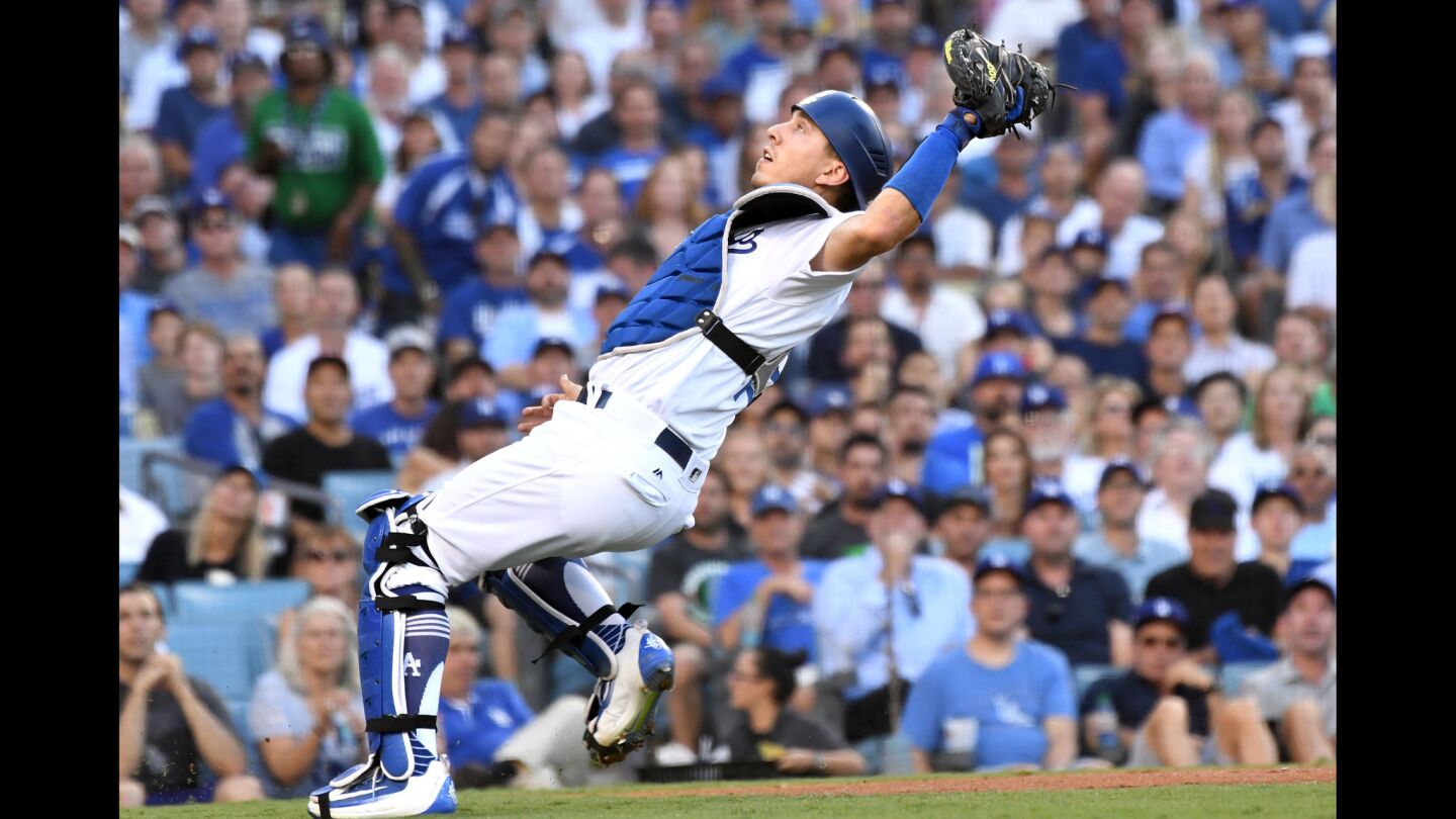Dodgers catcher Austin Barnes catches a foul ball hit by Astros third baseman Alex Bregman during the first inning.
