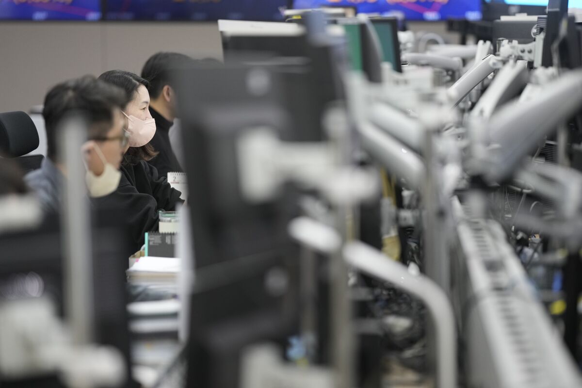 Currency traders watch computer monitors at a foreign exchange dealing room in Seoul, South Korea, Wednesday, Feb. 1, 2023. Asian stock markets were higher Wednesday after Wall Street rose ahead of what traders hope will be the last Federal Reserve interest rate hike for some time. (AP Photo/Lee Jin-man)