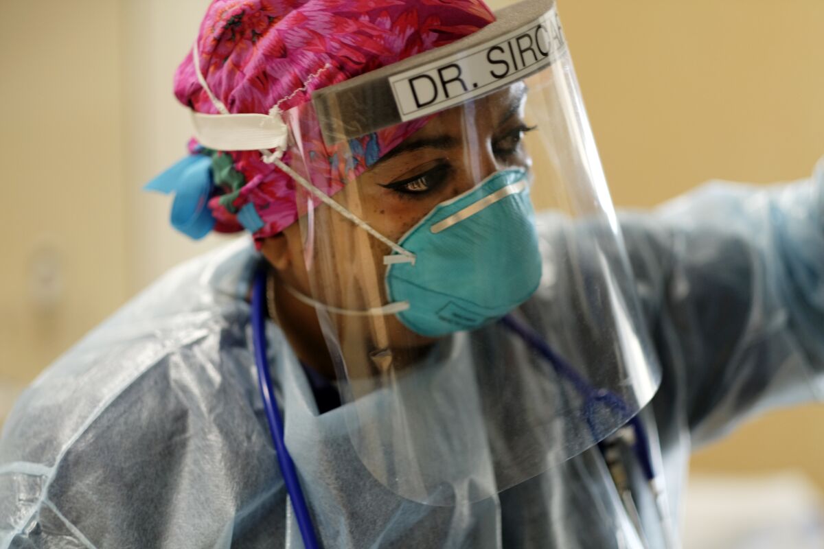 Dr. Anita Sircar examines a COVID-19 patient inside Little Company of Mary Medical Center.