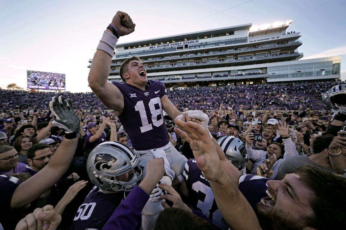 Kansas State quarterback Will Howard (18) celebrates with the crowd as he is carried off the field by teammates after an NCAA college football game against Oklahoma State Saturday, Oct. 29, 2022, in Manhattan, Kan. Kansas State won 48-0. (AP Photo/Charlie Riedel)