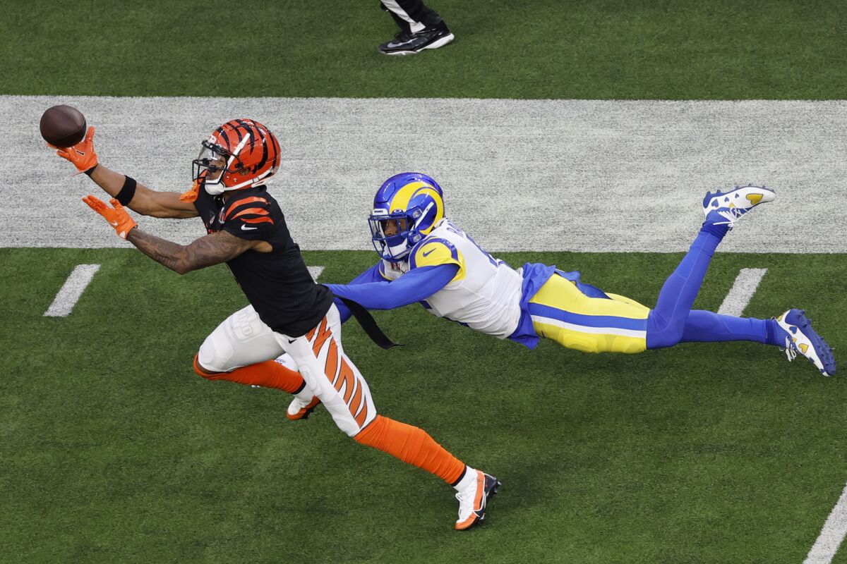 Cincinnati Bengals wide receiver Ja'Marr Chase makes a catch as Rams cornerback Jalen Ramsey defends