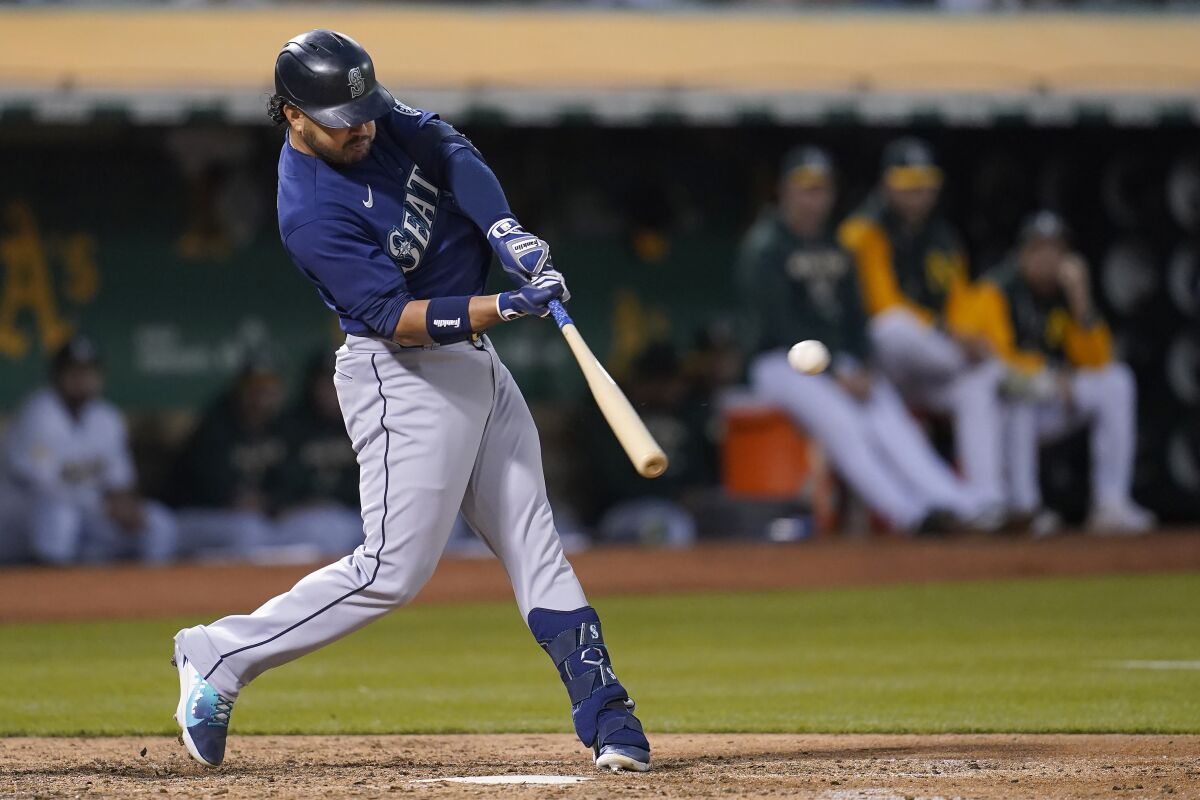 Seattle Mariners' Eugenio Suarez hits a three-run home run against the Oakland Athletics during the sixth inning of a baseball game in Oakland, Calif., Friday, Aug. 19, 2022. (AP Photo/Jeff Chiu)