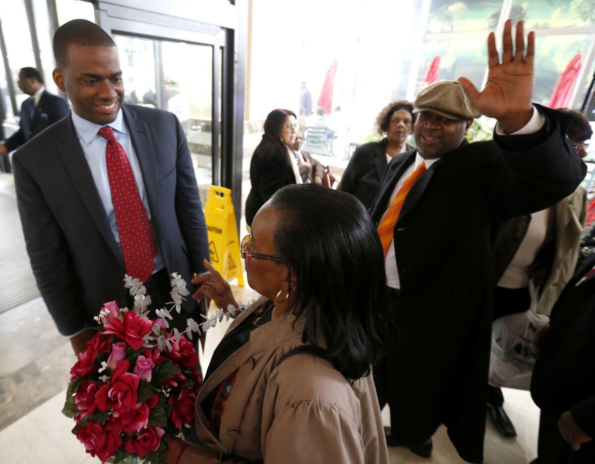 Newark, N.J., mayoral candidates Shavar Jeffries, left, and Ras Baraka, right, greet possible supporters leaving the city's annual senior citizen fashion show on Thursday.