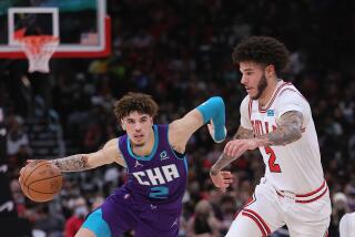 Hornets guard LaMelo Ball, left, drives against Bulls guard Lonzo Ball during a game.