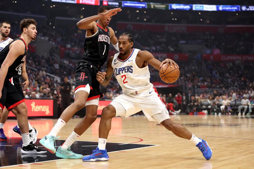 LOS ANGELES, CALIFORNIA - JANUARY 15: Kawhi Leonard #2 of the LA Clippers dribbles into the defense of Jabari Smith Jr. #1 of the Houston Rockets during the first half of a game at Crypto.com Arena on January 15, 2023 in Los Angeles, California. NOTE TO USER: User expressly acknowledges and agrees that, by downloading and or using this photograph, User is consenting to the terms and conditions of the Getty Images License Agreement. (Photo by Sean M. Haffey/Getty Images)