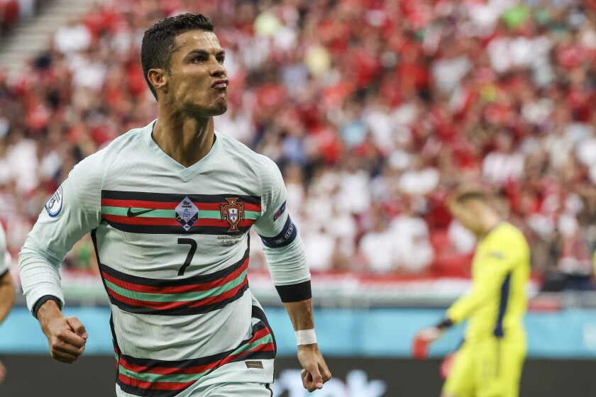 Portugal's Cristiano Ronaldo celebrates after scoring his second team goal during the Euro 2020 soccer championship group F match between Hungary and Portugal at the Ferenc Puskas stadium in Budapest, Hungary, Tuesday, June 15, 2021. (Bernadett Szabo/Pool via AP)