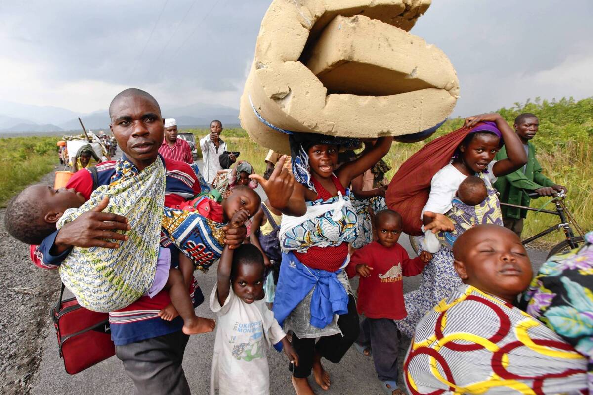 Congolese flee with their belongings to avoid fighting between rebels and government troops last month.