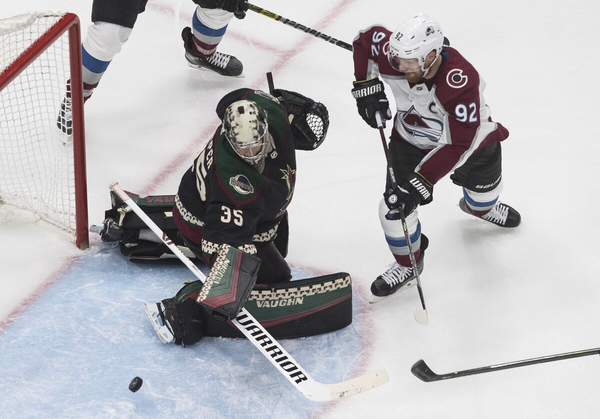 Colorado Avalanche's Gabriel Landeskog (92) is stopped by Arizona Coyotes goalie Darcy Kuemper (35) during the second period of an NHL hockey Stanley Cup first-round playoff series, Saturday, Aug. 15, 2020, in Edmonton, Alberta. (Jason Franson/The Canadian Press via AP)