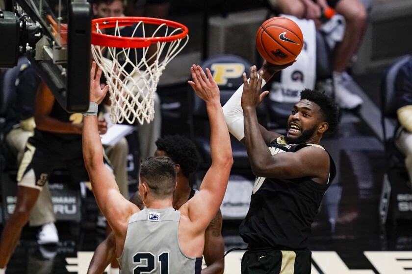 Purdue forward Trevion Williams, right, shoots over Penn State forward John Harrar (21) during the second half of an NCAA college basketball game in West Lafayette, Ind., Sunday, Jan. 17, 2021. (AP Photo/Michael Conroy)