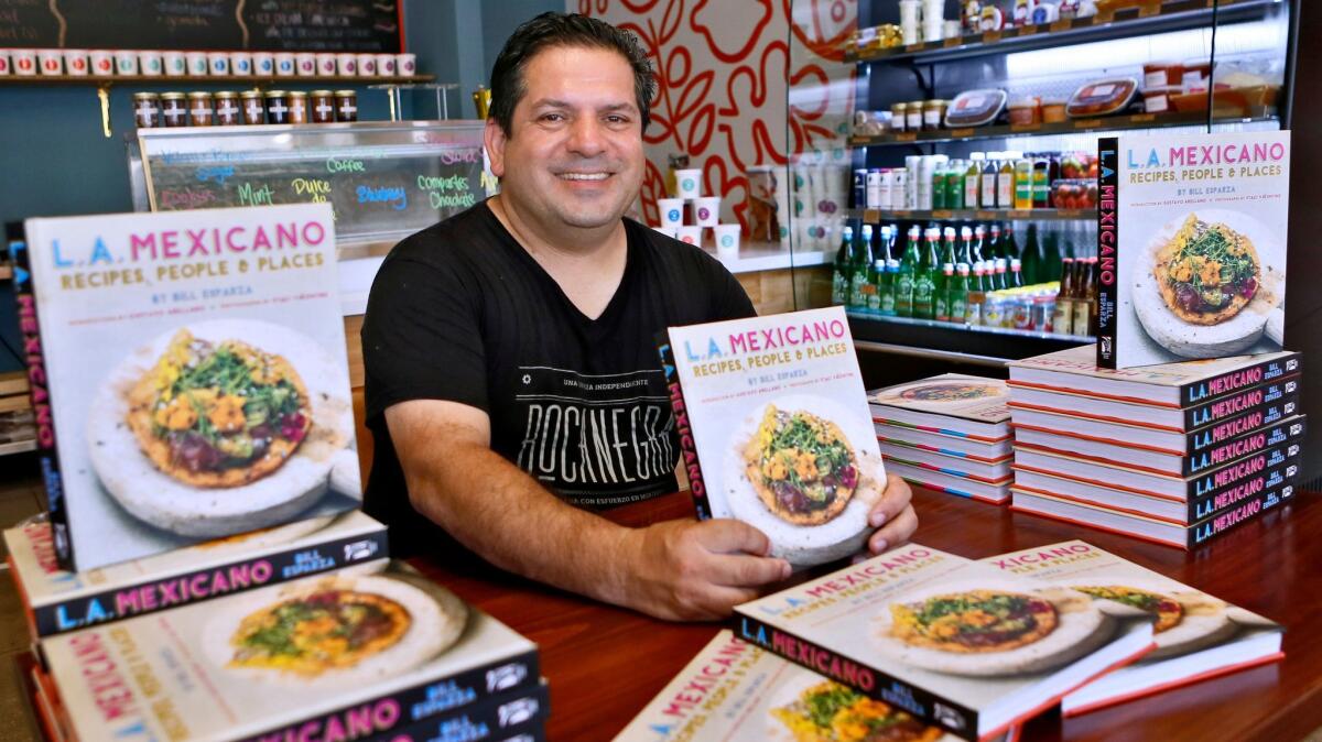 John Muir Middle School teacher Bill Esparza signs "L.A. Mexicano, Recipes, People and Places" at Friends and Family Restaurant in Los Angeles on Saturday, July 8, 2017.