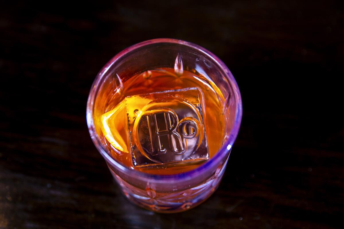 A cocktail with a branded ice cube 