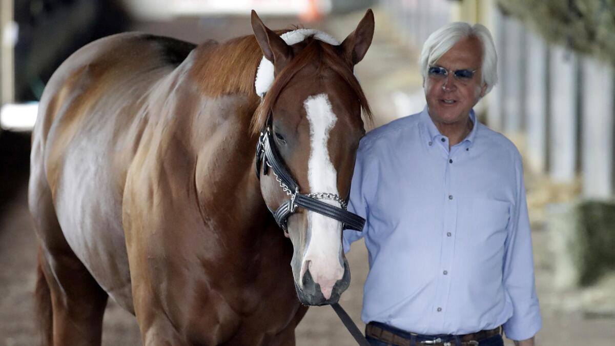 Trainer Bob Baffert walks Justify around the barn after they arrived in New York last month for the Belmont Stakes.