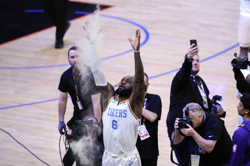 Los Angeles Lakers' LeBron James tosses powder before an NBA basketball game against the New York Knicks Tuesday, Jan. 31, 2023, in New York. (AP Photo/Frank Franklin II)