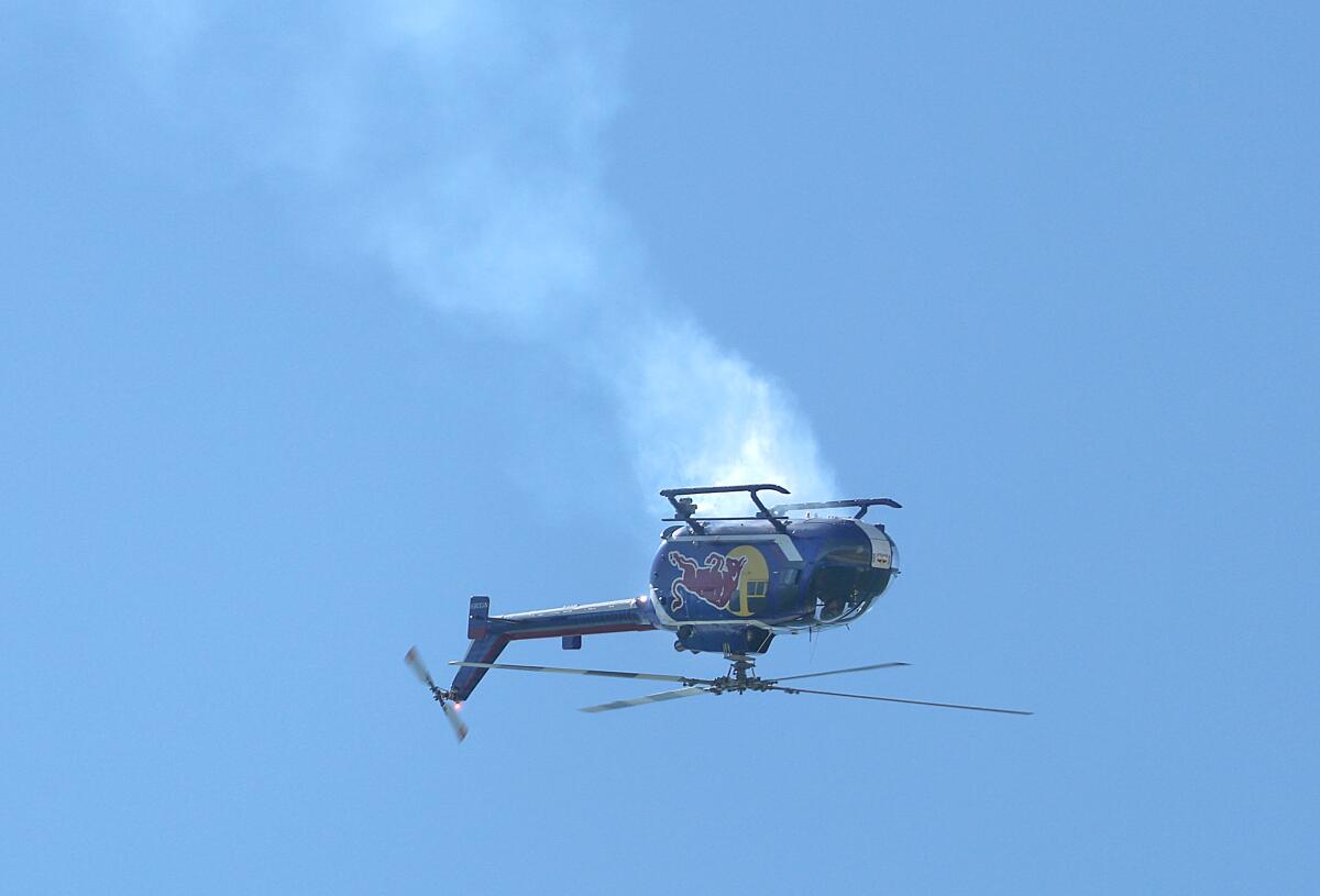 A helicopter flying with Aaron Fitzgerald flips during Pacific Airshow on Friday.