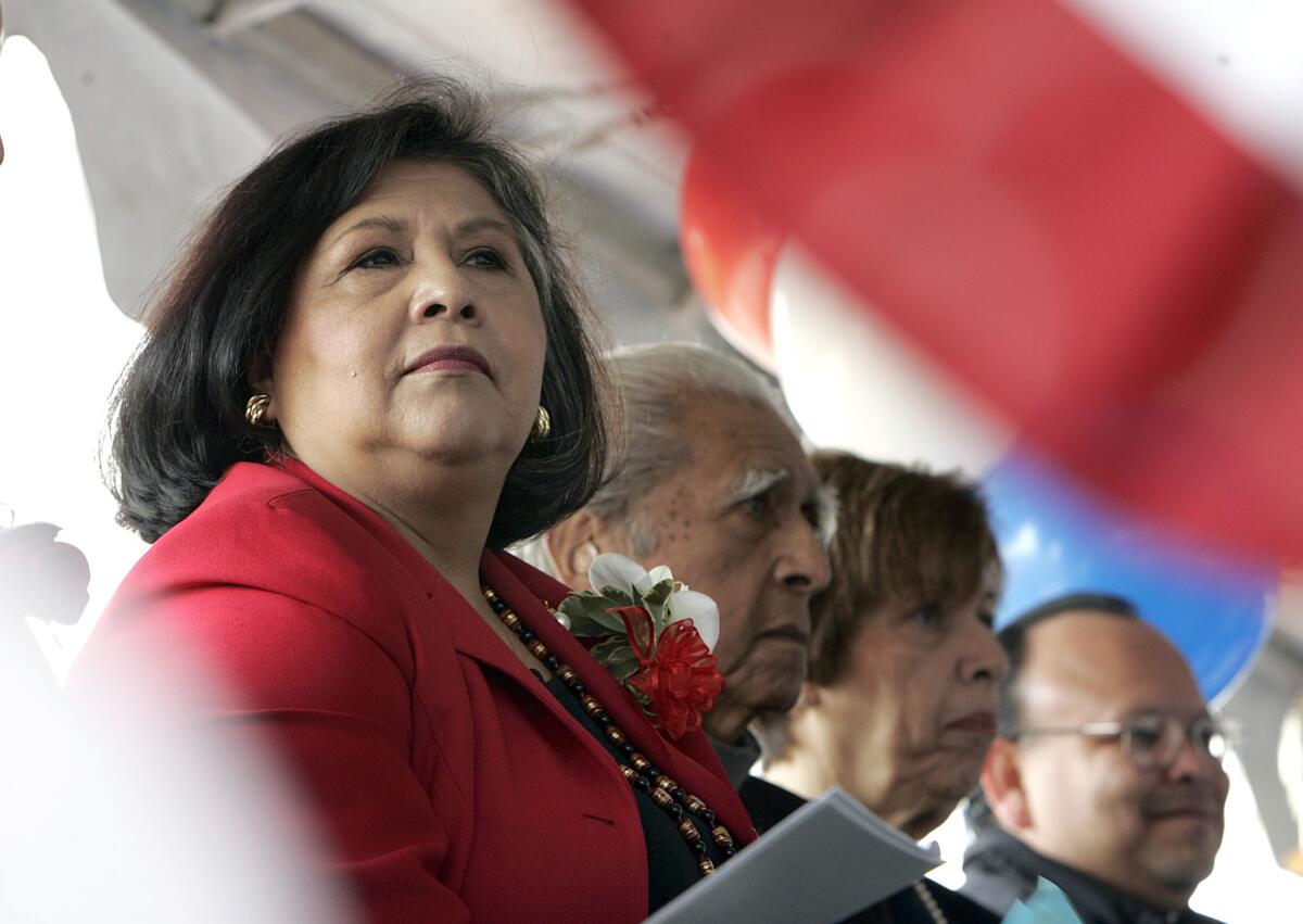 Gloria Molina stands next to three other people.