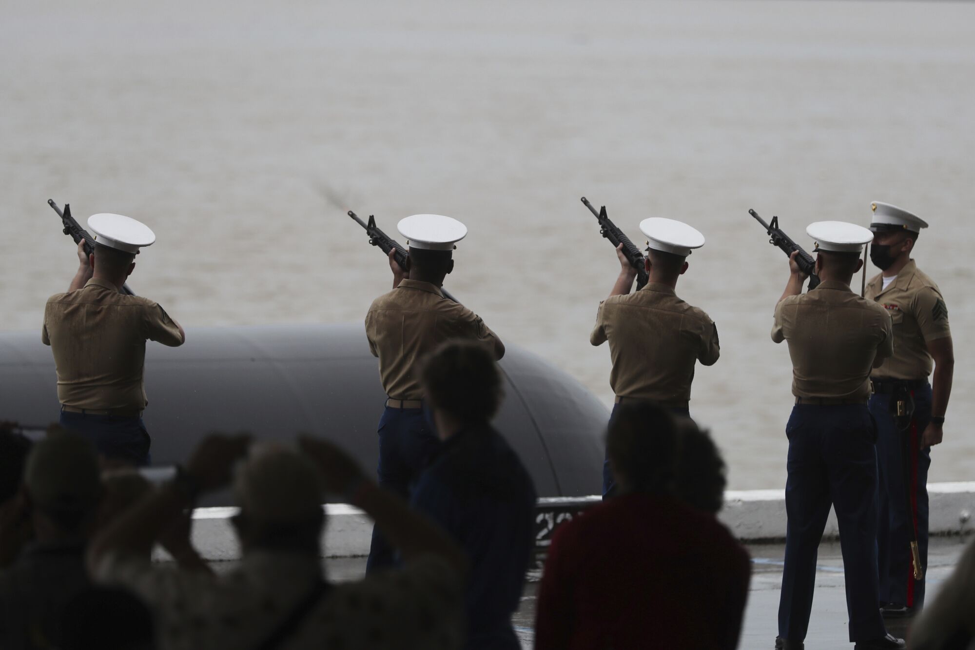 Marines fire a rifle salute at the Pearl Harbor  80th anniversary ceremony 