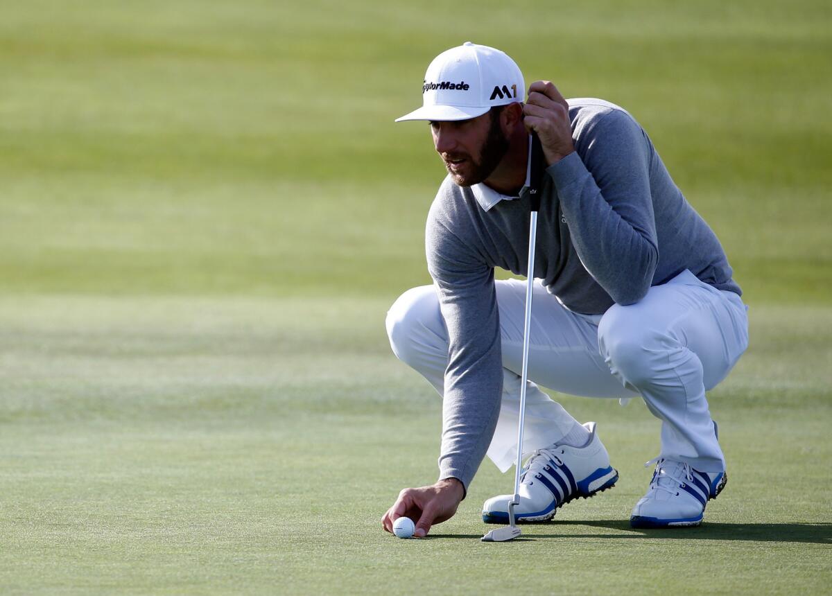 Dustin Johnson marks his ball on the 15th green during the second round of the AT&T Pebble Beach National Pro-Am on Feb. 12.